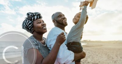 A joyful family on the beach, symbolizing freedom, aspiration, and a brighter future through global mobility and citizenship opportunities